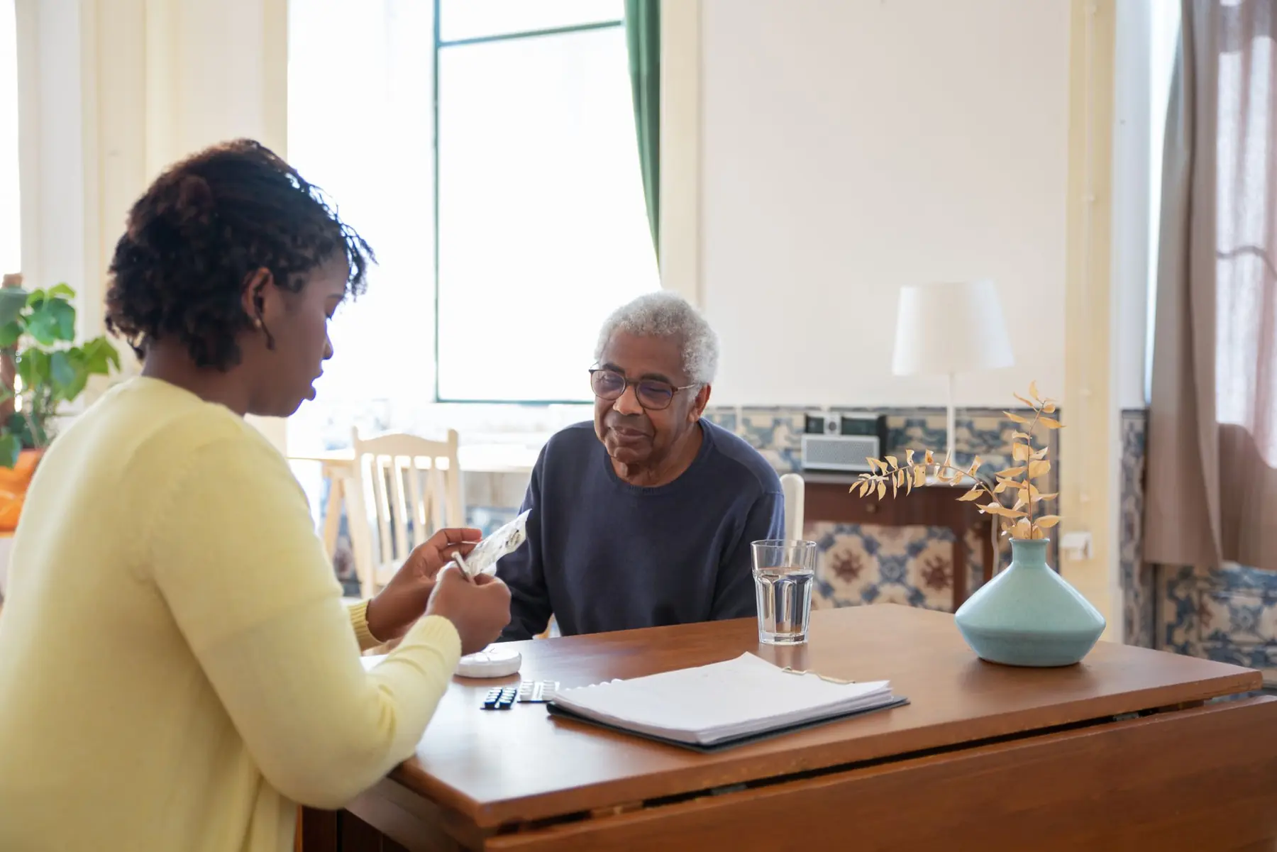 A caregiver from A & D Home Care visiting an older client at home