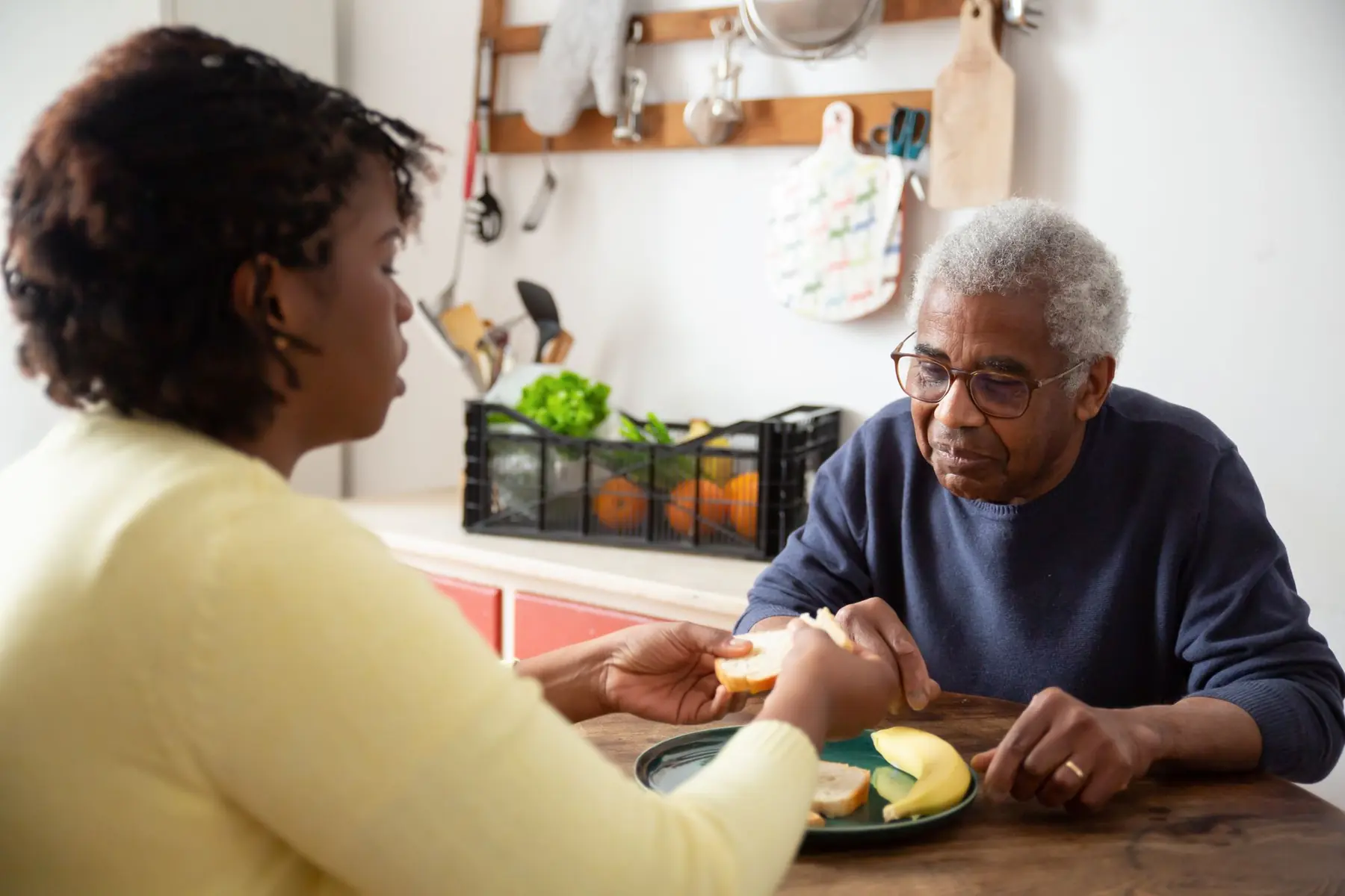 Caregiver assisting a senior with daily care at home