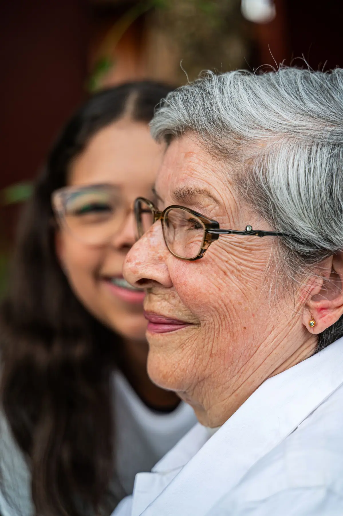 Caregiver and senior woman laughing together at home